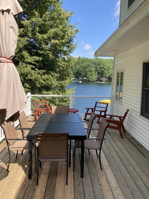 Enjoy a serene view from this outdoor deck overlooking the water.