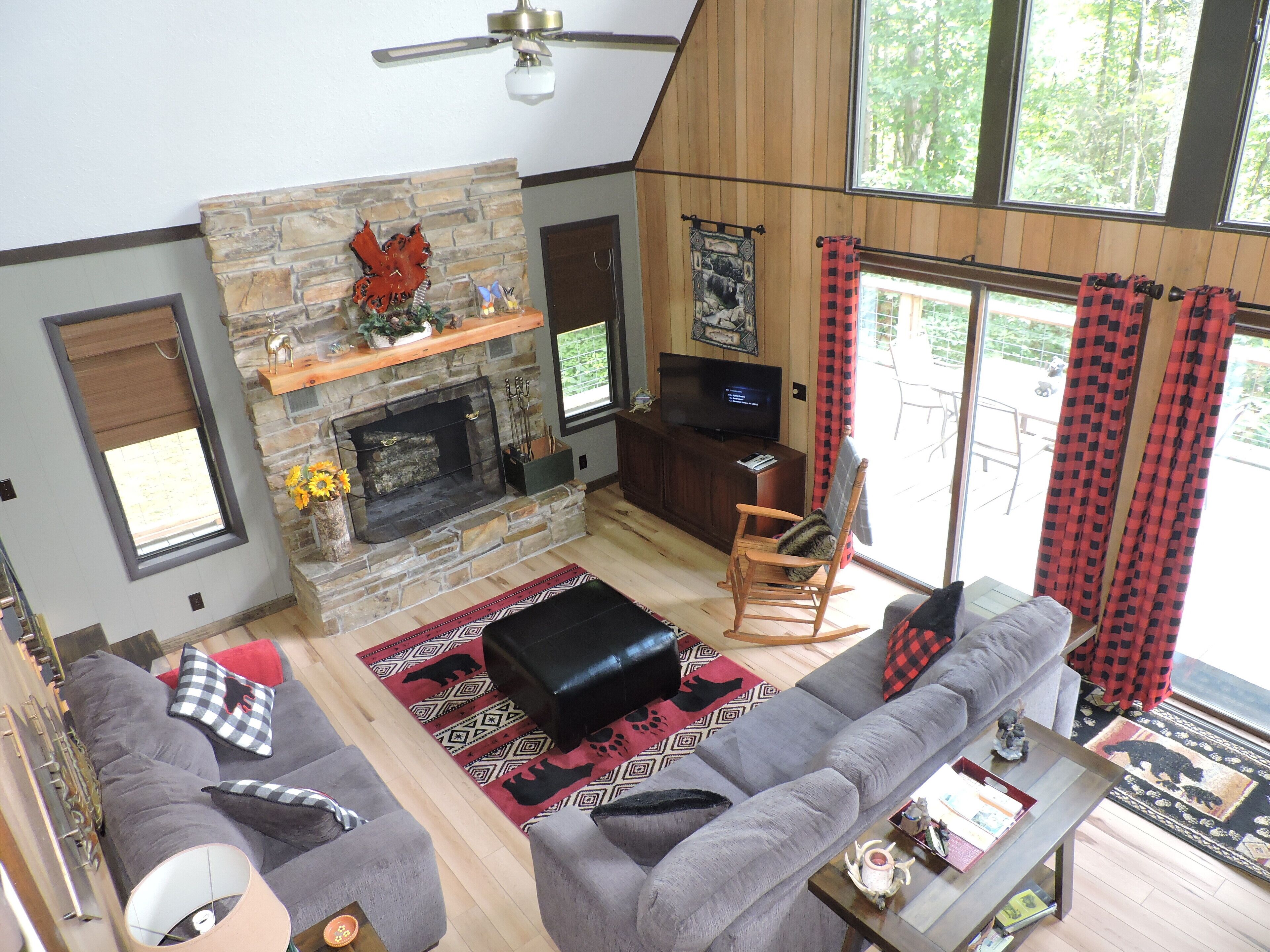 Great room w/wood burning fireplace, a 42"  TV, sofa, loveseat & rocking chair.