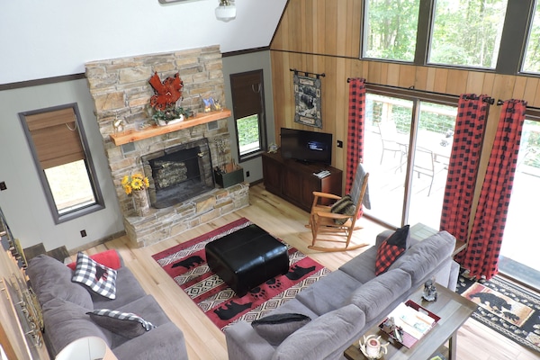 Great room w/wood burning fireplace, a 42" TV, sofa, loveseat & rocking chair.