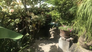 A garden pathway surrounded by lush greenery and flowering plants. - Treehouse Hideaway Villa I--A Nature Packed Soufriere Experience (Soufriere)