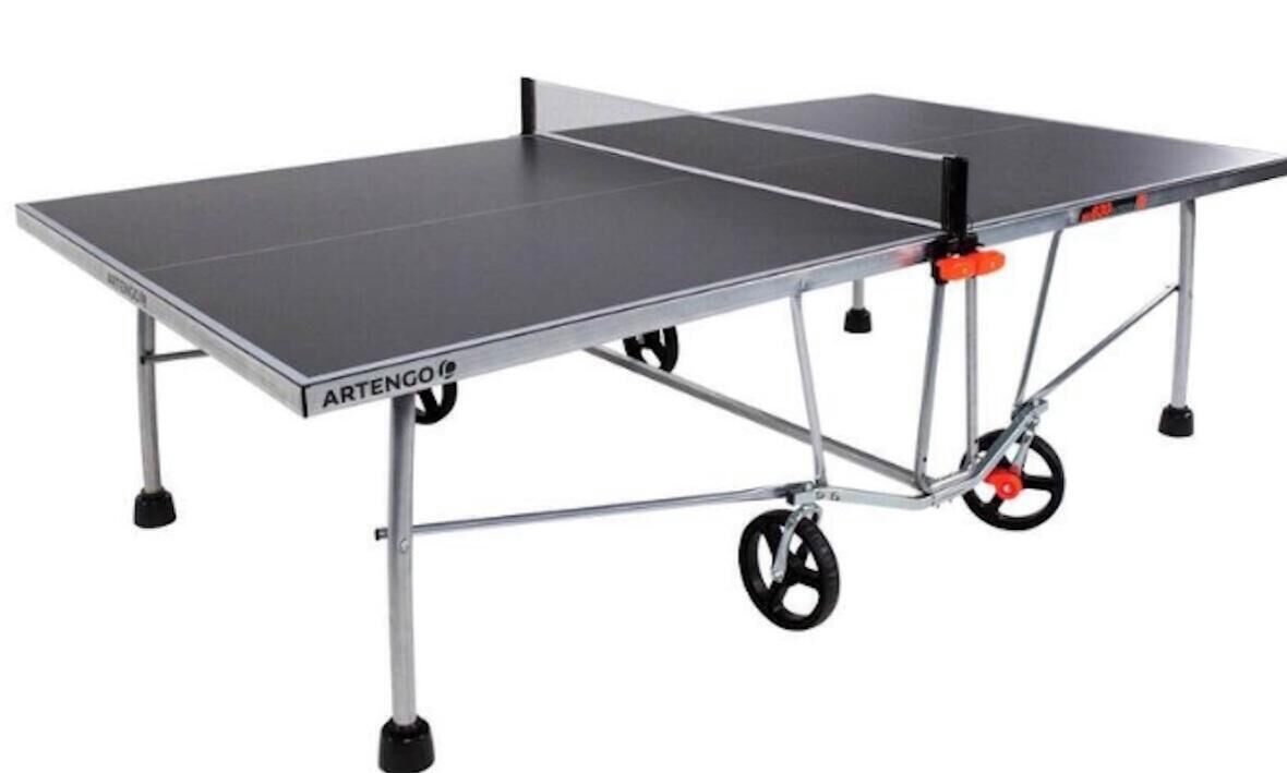 A table tennis table with wheels and a metal frame.