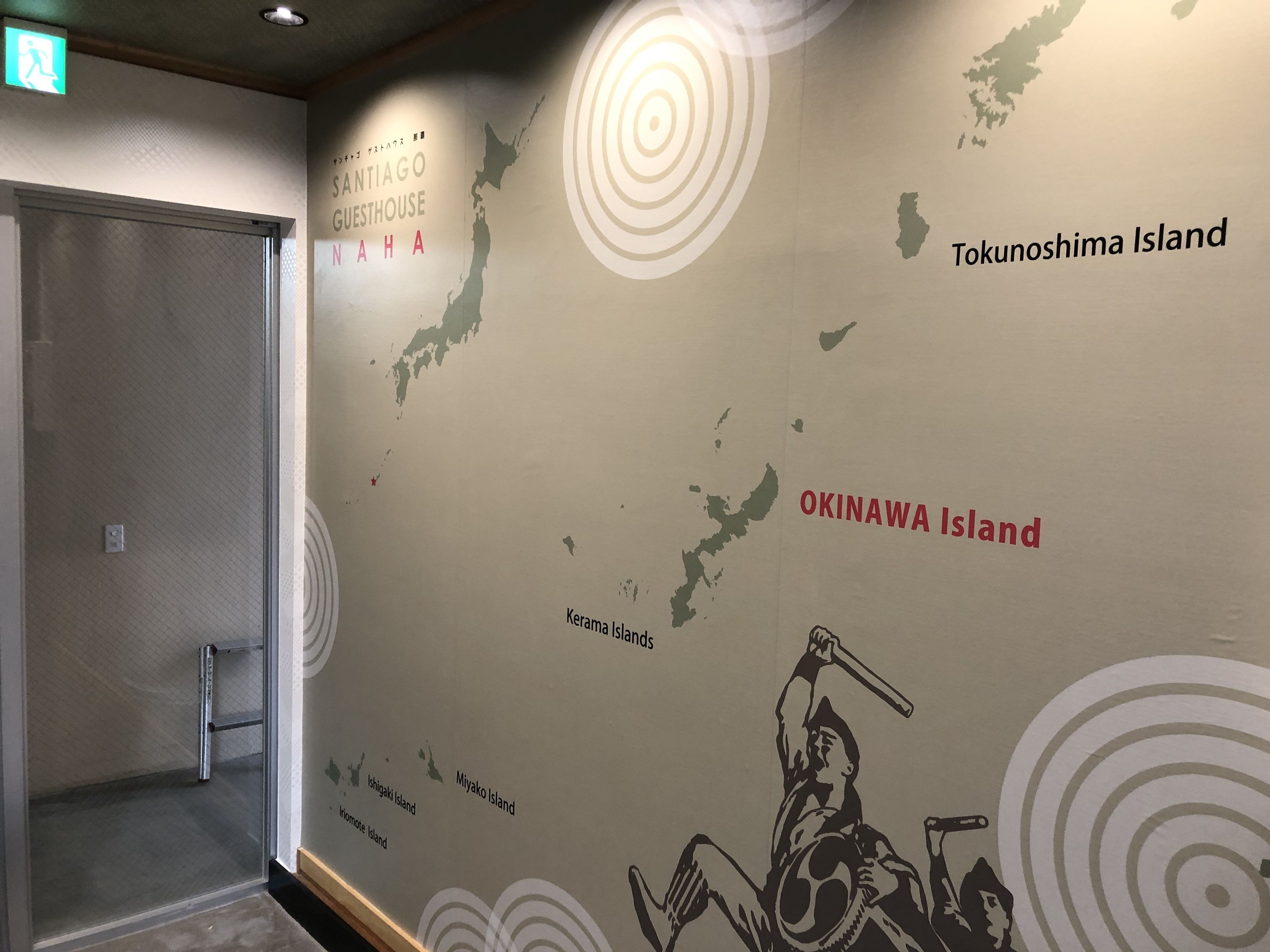 A wall with a map of Okinawa Islands, including Okinawa Island, Tokunoshima Island, and Kerama Islands.