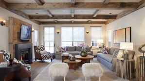 A cozy living room with a fireplace, comfortable seating, and a television. -  Come Home To Tomorrow's Comforts in Historic CB! Book for summer soon!! (Crested Butte)