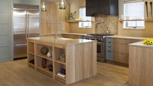 A modern kitchen with wooden cabinets, a stainless steel refrigerator, a central island with a sink, and a gas stove. -  Come Home To Tomorrow's Comforts in Historic CB! Book for summer soon!! (Crested Butte)