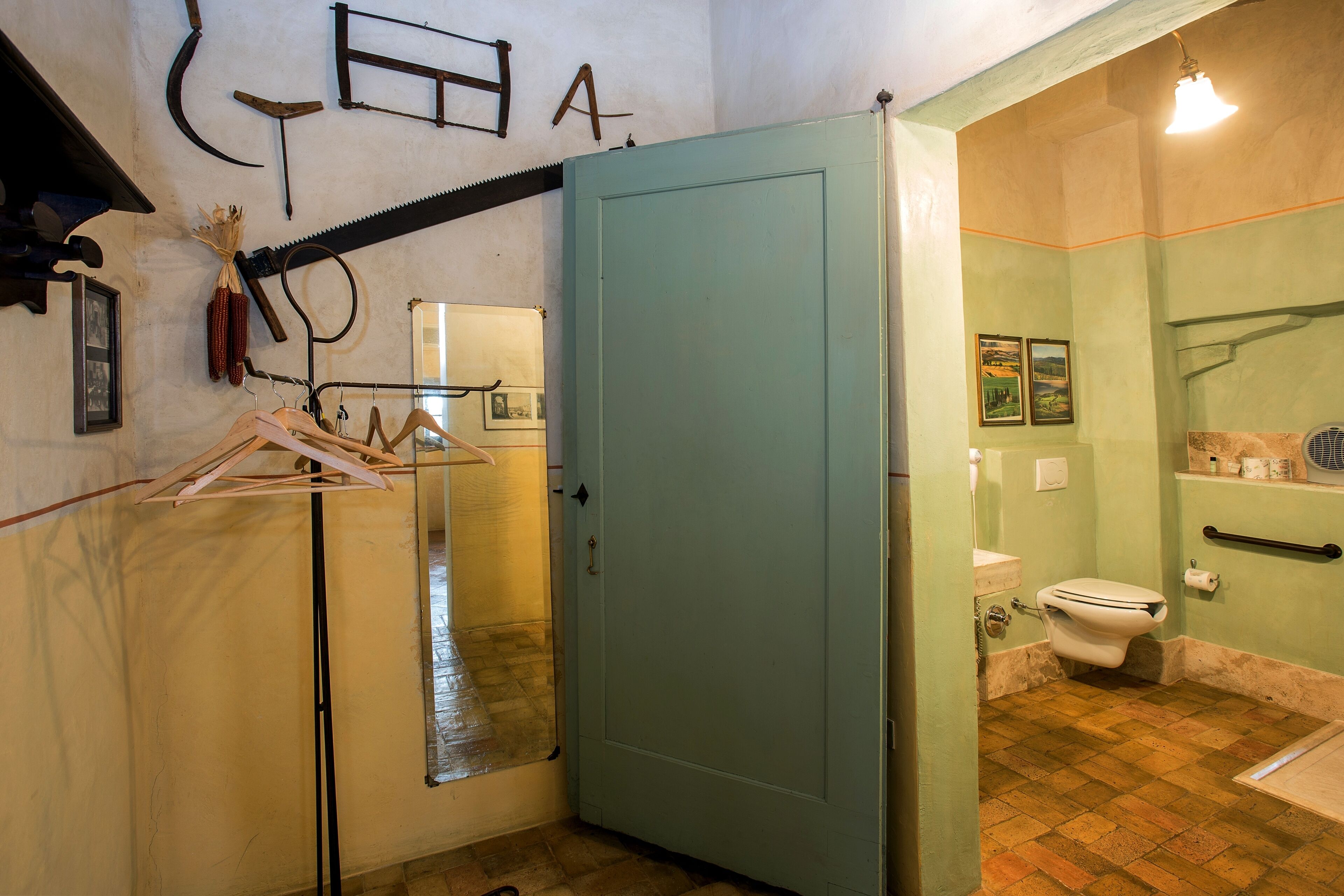 A bathroom with a toilet, sink, and shower area.