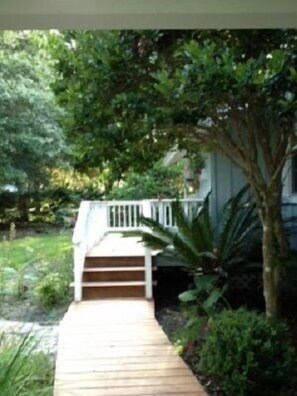 Guests can enjoy a porch surrounded by lush greenery.