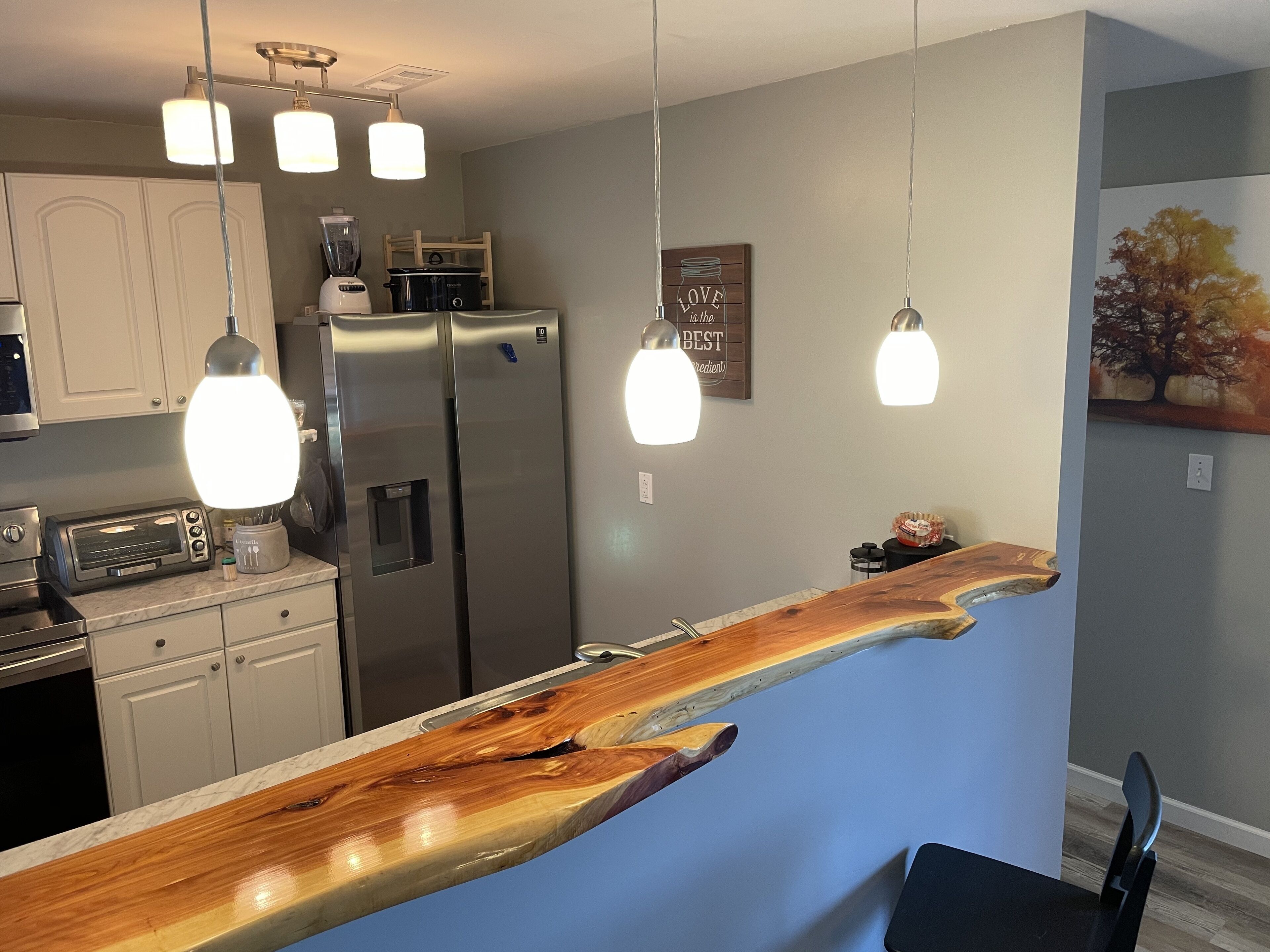 Our beautiful kitchen with live edge cedar bar top and brand new appliances