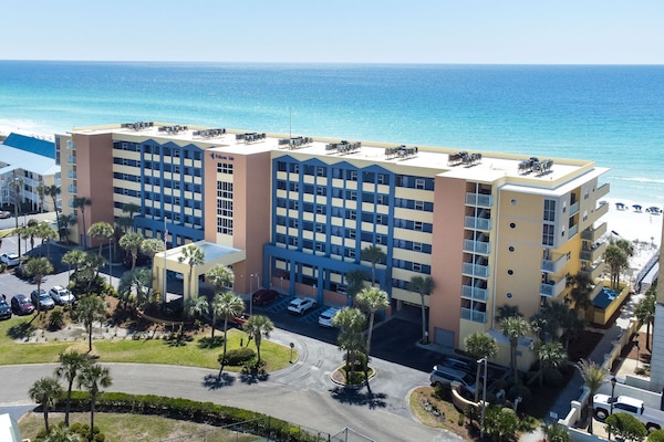 Birdseye view of Pelican Isle. Straight on view of the gulf. Wide beach front.