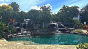 A pool with clear water, surrounded by rocks and tropical plants. - North Shore Beauty!  2B with Kitchen in Resort near Hanalei (Princeville)