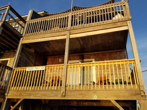 A multi-level wooden structure with balconies, a sign indicating 'MARINERS TERRACE.COM', and a visible number '10'. - Waterfront Condo. Amazing Sunsets over Pamlico Sound. Pool, Pickleball & Tennis! (Avon)