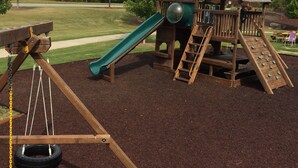 A playground with a swing set, a slide, and a climbing structure. - Affordable Private Lake Front House (Waleska)