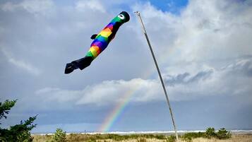 A rainbow-colored kite flying high in the sky.