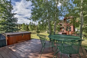 Relax on the elevated deck with a hot tub and outdoor seating area.