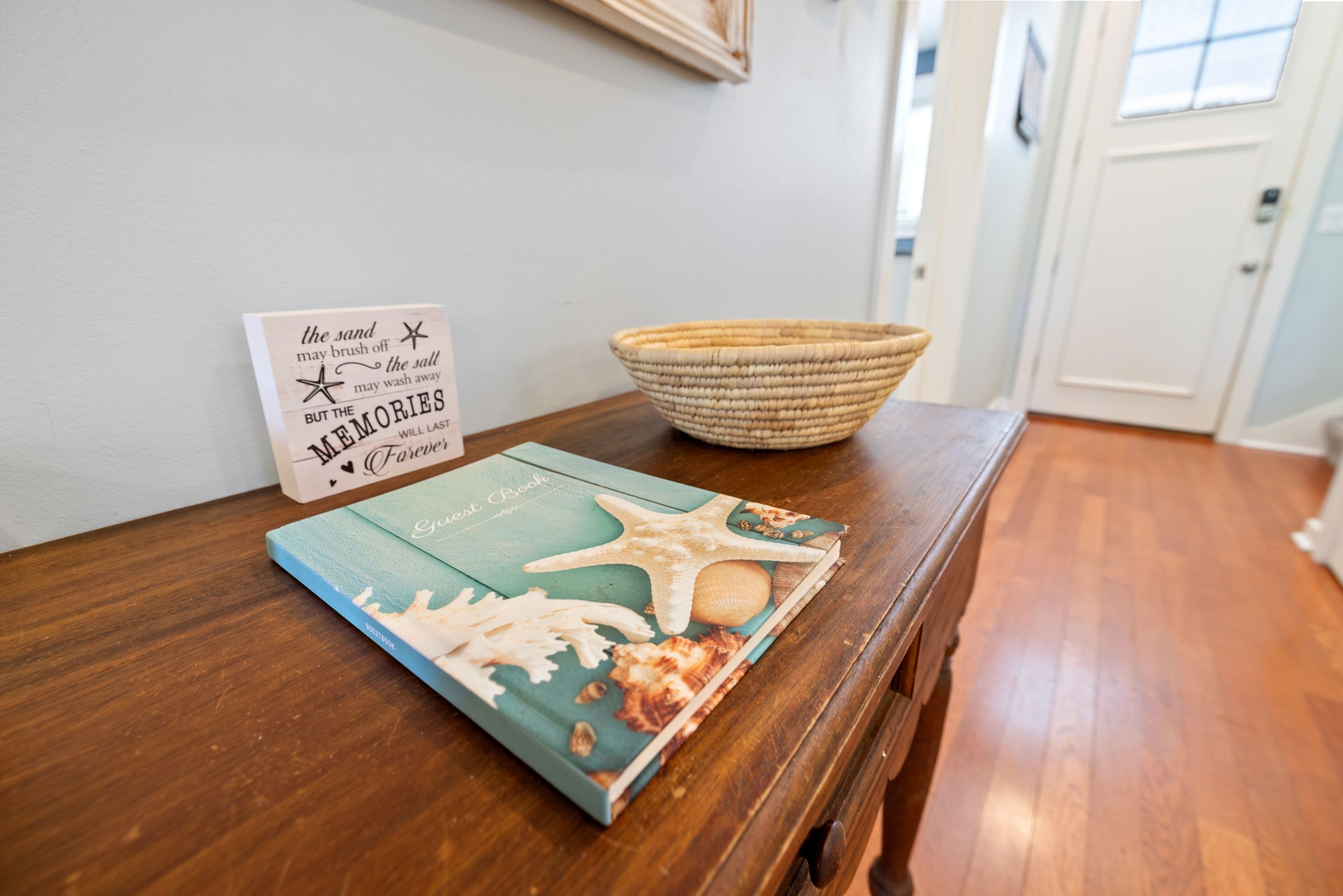 A wooden table with a book and a sign.