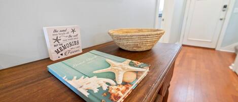 A wooden table with a book and a sign.