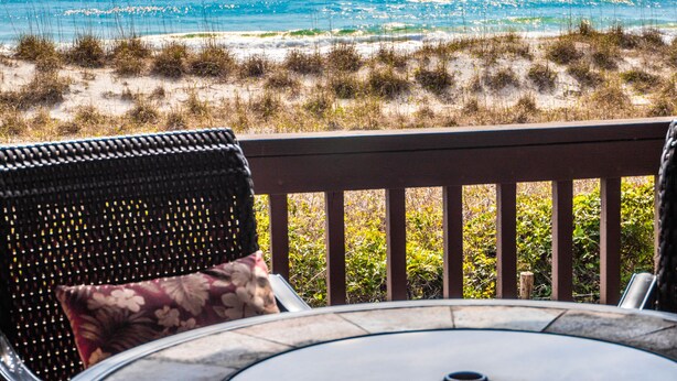 A deck with wicker furniture and a view of the ocean. - Sea Colony 2A | Oceanfront, Private Beach Walkway (Carolina Beach)