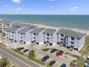 A beachfront hotel with multiple-story buildings, parking, and a view of the ocean. - Sea Colony 2A | Oceanfront, Private Beach Walkway (Carolina Beach)