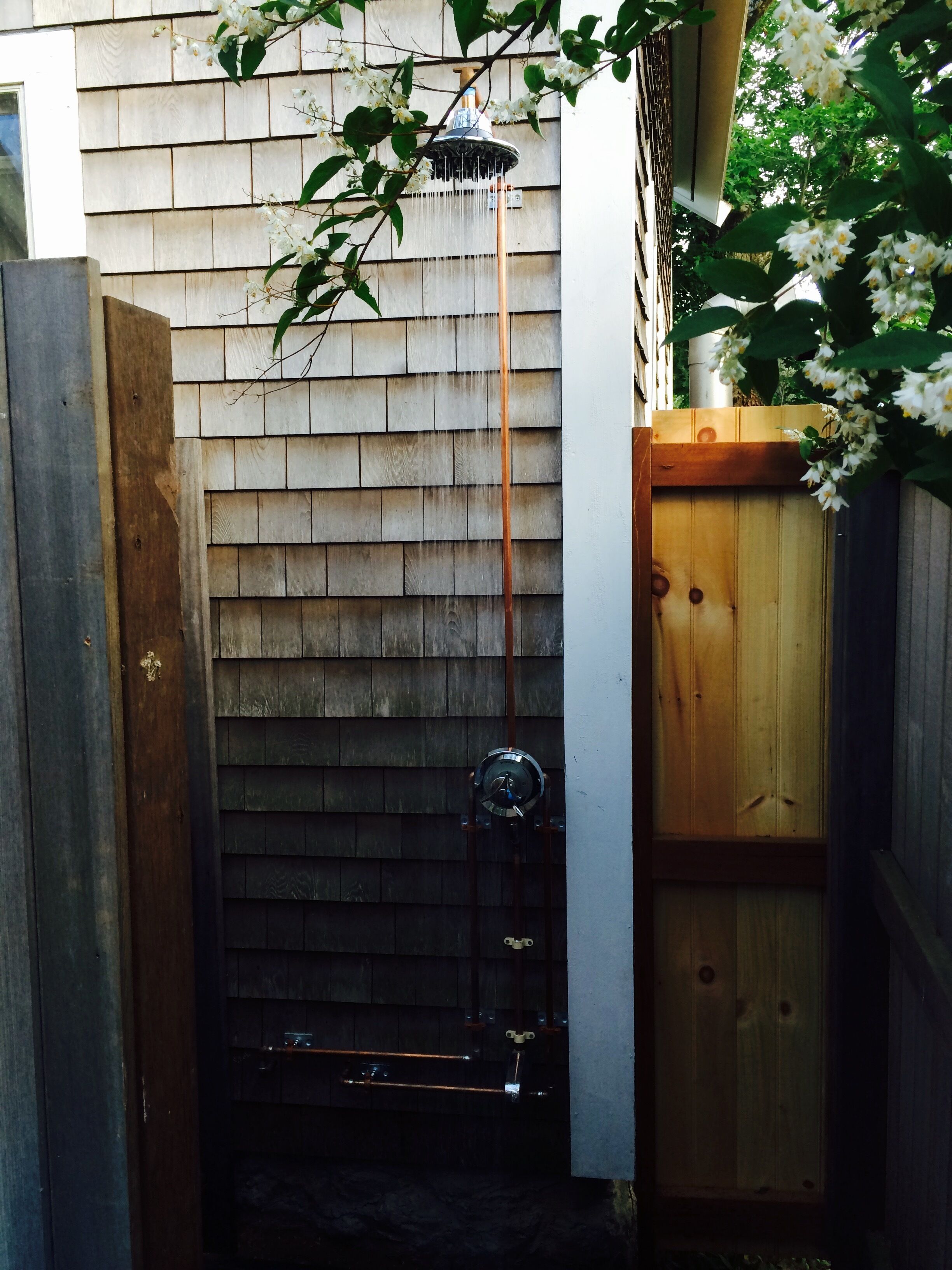 Outdoor shower with over-sized rainfall shower head. 