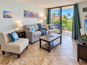 A living room with a sofa, armchairs, a coffee table, and artwork on the walls. - Scenic Kihei Village by the Sea Renovated Condo Ocean Views Lanai Pool (Kihei)