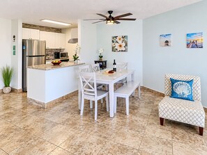 A modern kitchen with a built-in island, white cabinetry, and a stainless steel refrigerator. - Scenic Kihei Village by the Sea Renovated Condo Ocean Views Lanai Pool (Kihei)