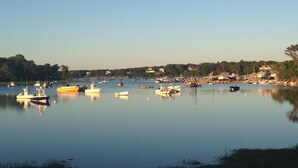A calm harbor with various boats docked.