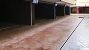 Filas de espacios de estacionamiento con un letrero que indica zona de estacionamiento las 24 horas.