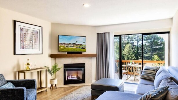 A living room with a fireplace, a television, and a sofa.