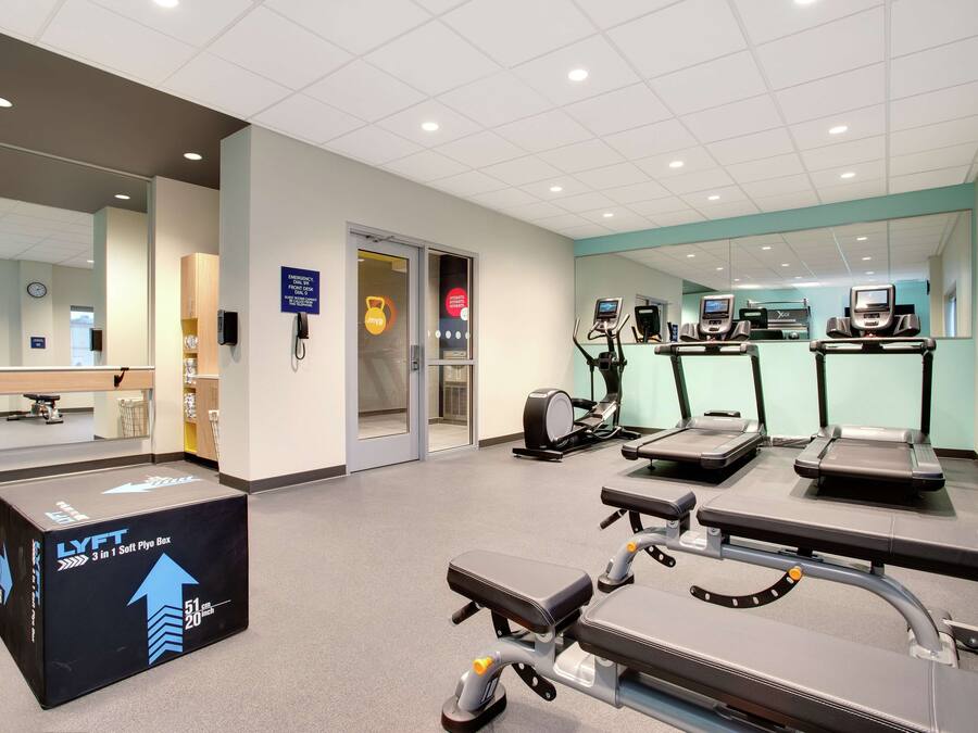 A gym with treadmills, a soft plyo box, and exercise equipment.