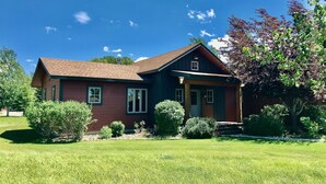 A two-story house with a brown roof and a front porch. - Cozy Home on the Idaho side of the Teton mountains- AC and a View! (Driggs)