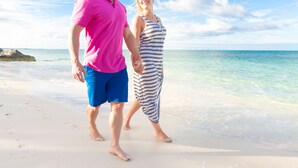 A couple walking on a sandy beach with clear skies and calm waters. - Idyllic Island Getaway, Private Beach Deck & Access (Providenciales)