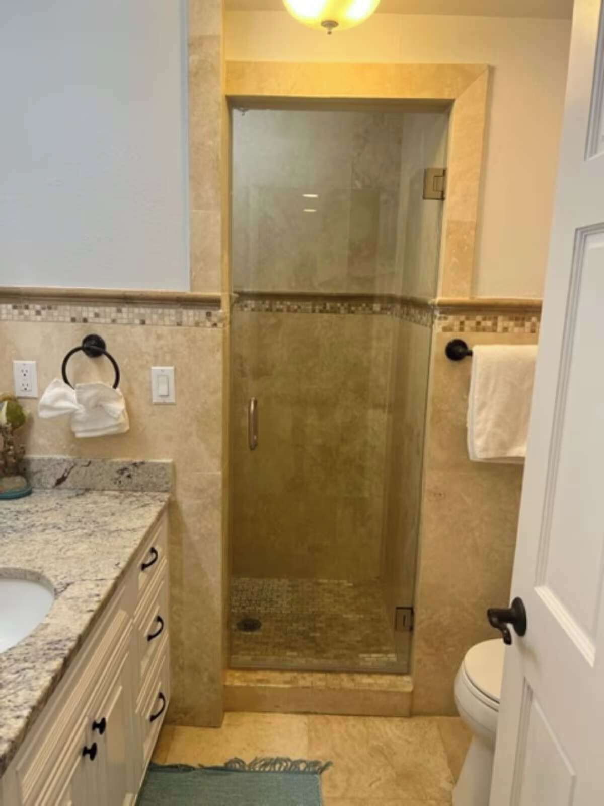 Une salle de bain avec une douche, un lavabo et des toilettes.