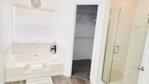 Combined shower/bathtub, hair dryer, towels, toilet paper