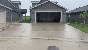 A residential driveway leading to a garage with a covered entryway.