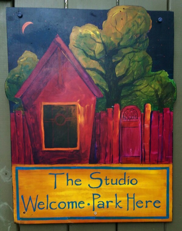 A colorful sign with a house and trees, indicating a studio welcome area. - Beautiful, Historic and Private Retreat for Couples-limit 2 people (Ocracoke)