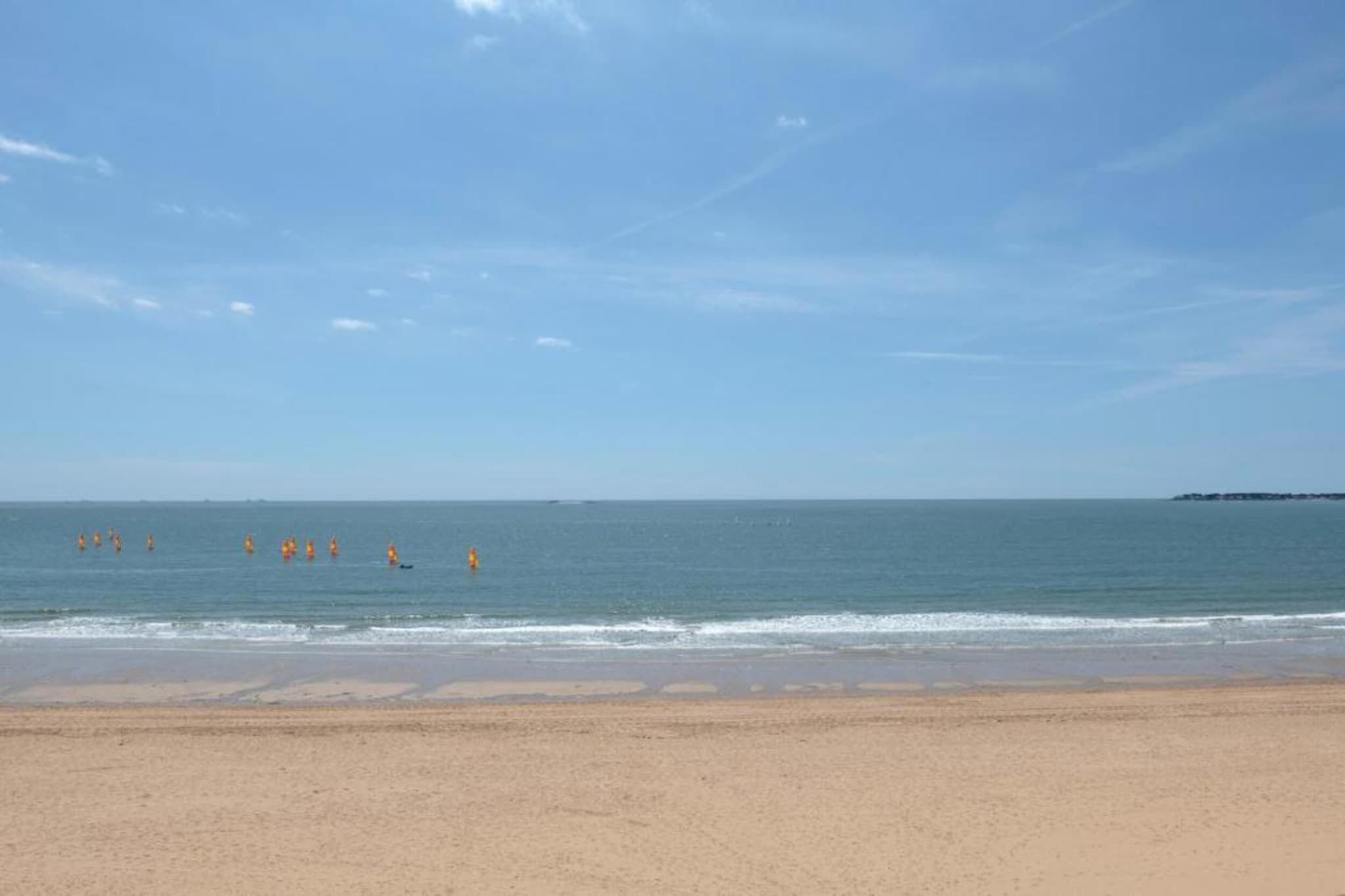 A beach with clear skies and calm water.