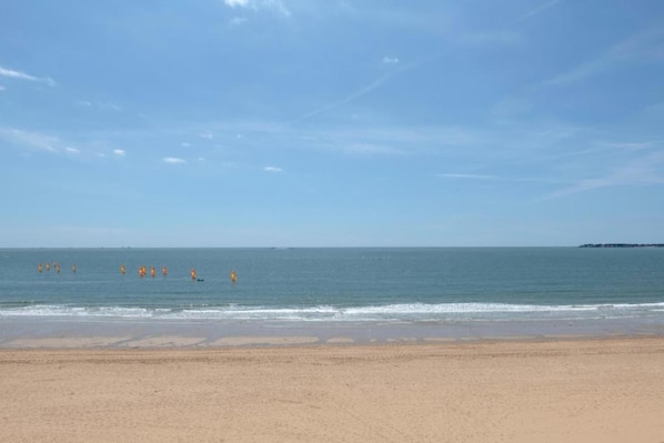 A beach with clear skies and calm water.