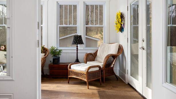 A cozy room with wicker furniture, a lamp, and a potted plant. - Afton Station Cottage -Beautifully Renovated Blue Ridge Scenic Historic Setting (Afton)