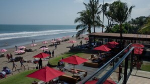 A beachside resort with red umbrellas, lounge areas, and a view of the ocean. - 50meter from Seminyak beach,2BR Villa  (Seminyak)