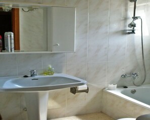 Bathtub, towels, soap, toilet paper