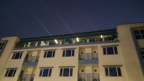 A multi-story hotel with balconies and a flat roof. - Grand Diamond Guest House (Mingaladon Township)