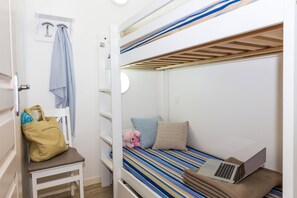 A bunk bed room with a laptop on the lower bunk, a teddy bear, and a bag on a chair. - Apartment in La Baule near Côte d’Amour (PORNICHET)
