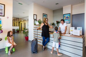 A reception area with a counter, a waiting area with chairs, and a hallway leading to other rooms.