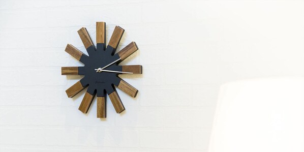A wall-mounted clock with a unique starburst design.