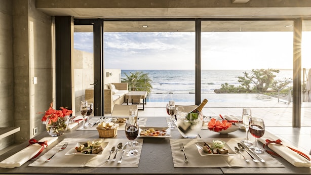 A dining table set for a meal with a view of the ocean. - D's GROW RESORT Infinity Pool Villa (Miyakojima)