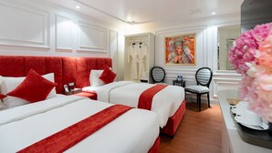A hotel room with two beds, a red headboard, white walls, a painting, and a mirror. - Diamond Hotel Sapa (Sa Pa)