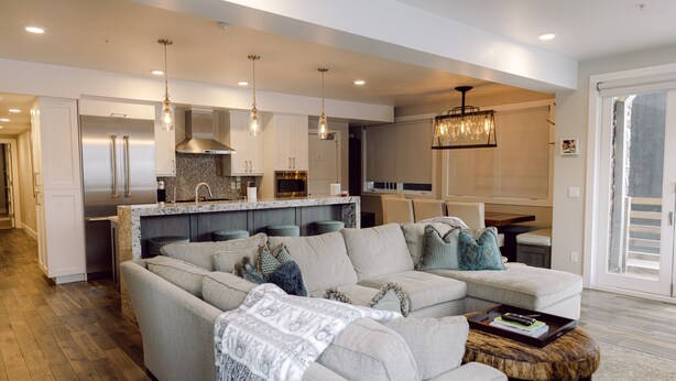 A modern kitchen with stainless steel appliances, a dining area with a large table, and a living room with a sectional sofa and a coffee table. -   Luxury Ski-In/Out Town Lift Walk to Main St (Park City)