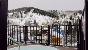 A hot tub on a wooden deck with a view of a snowy mountain and a ski lift in the background. -   Luxury Ski-In/Out Town Lift Walk to Main St (Park City)