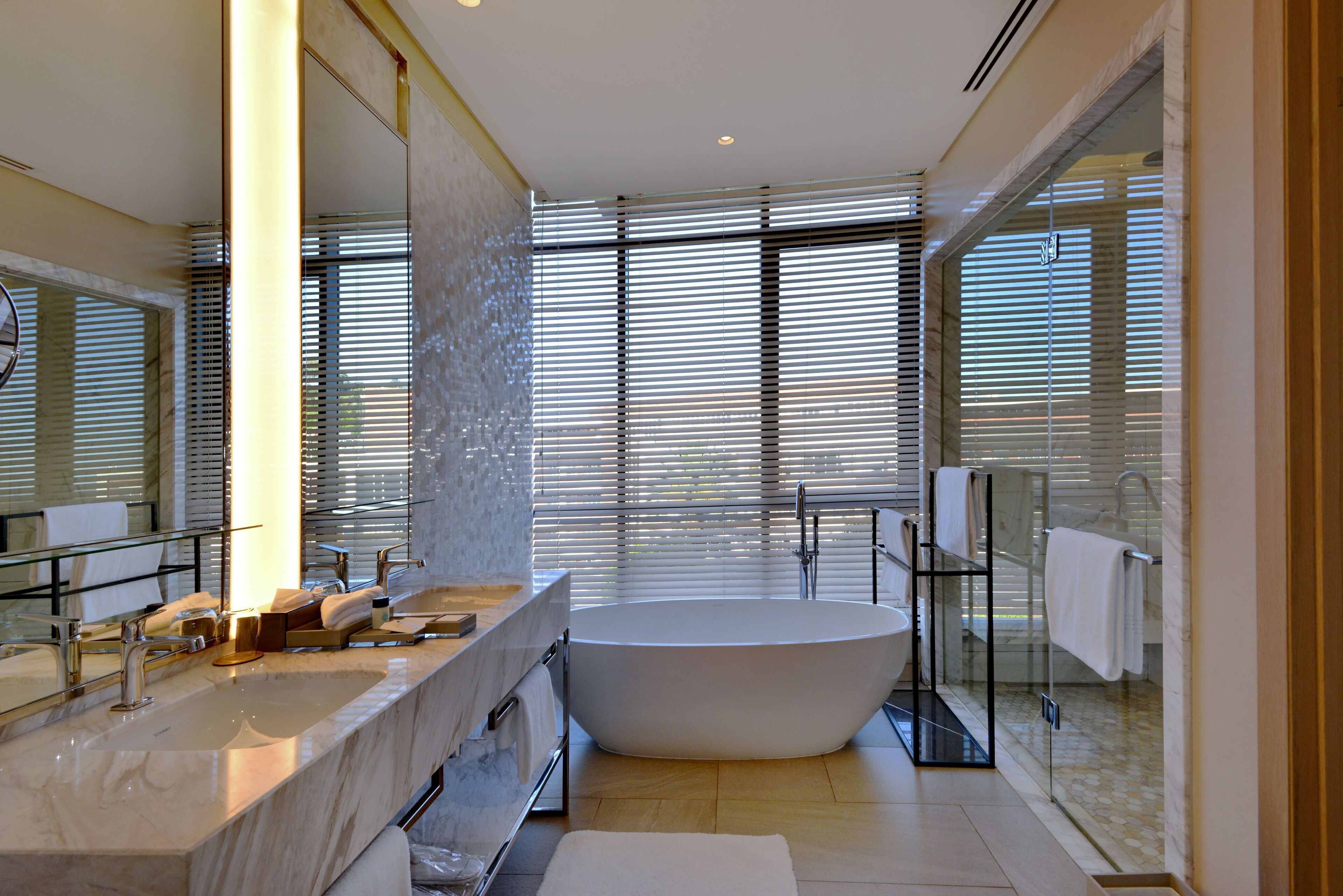 junior suite | bathroom | separate bathtub and shower, slippers, towels