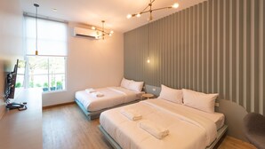 A modern hotel room with two beds, a desk, and a chair. - Boxpackers Hostel Phranakorn (Bangkok)