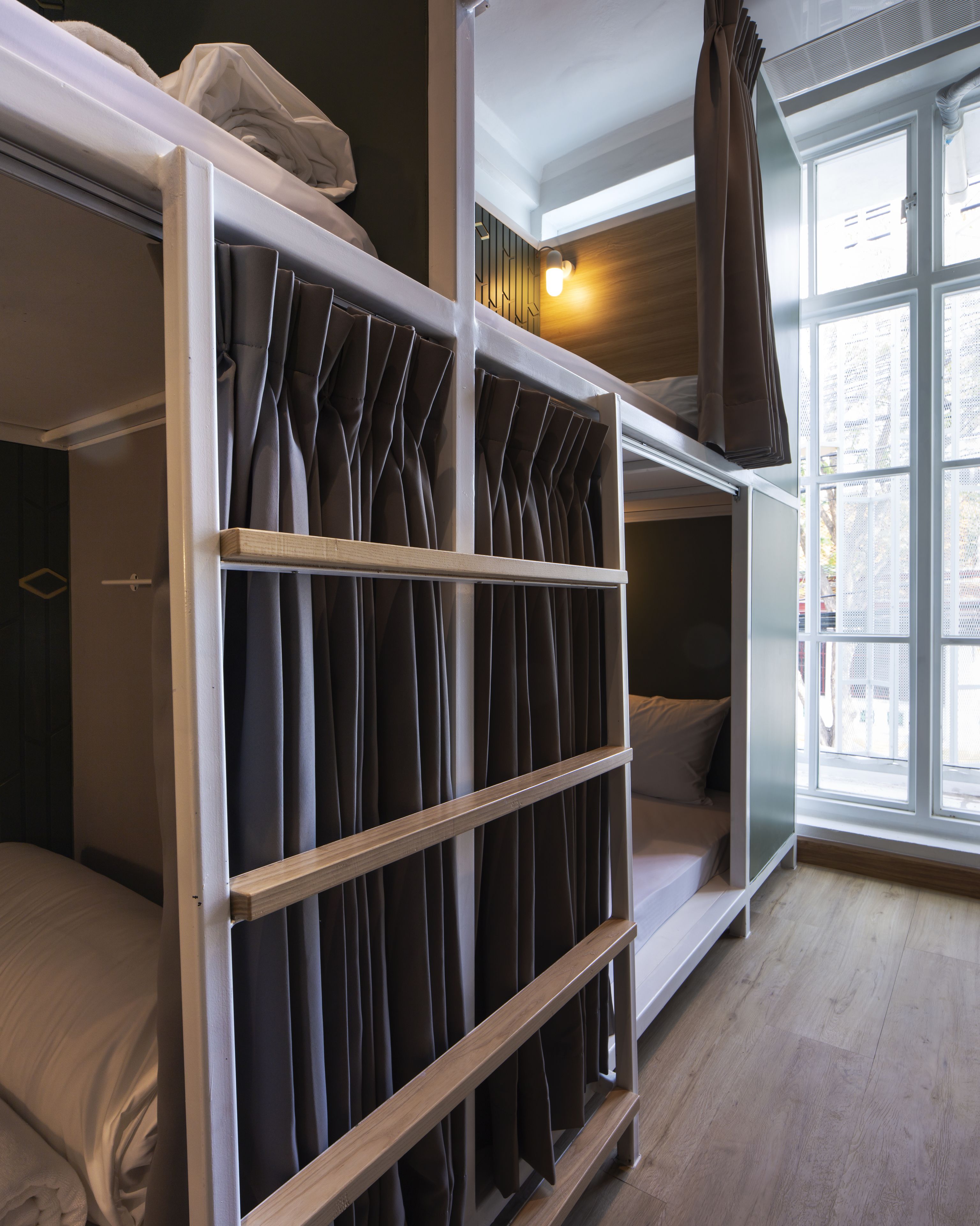 A bunk bed room with a window and curtains.